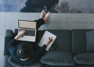 Man taking notes on his couch